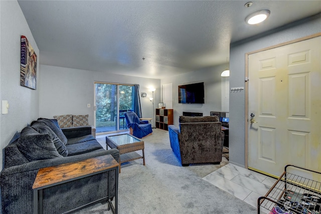 carpeted living room featuring a textured ceiling