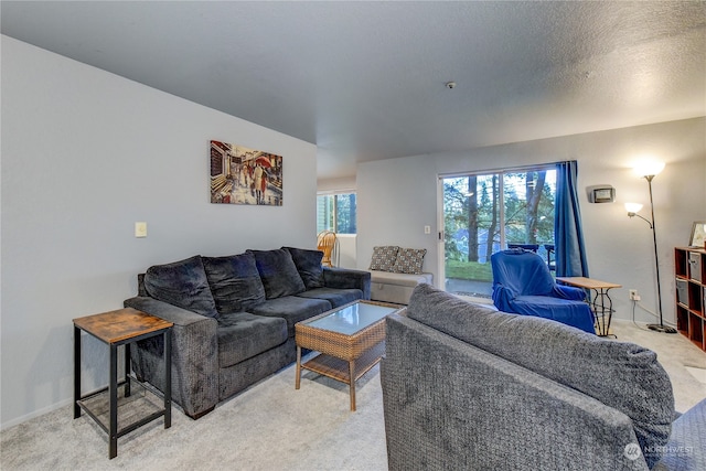 living room featuring light carpet and a textured ceiling