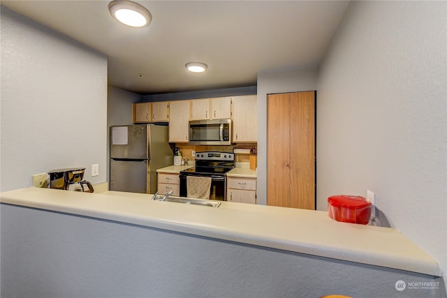 kitchen featuring sink, light brown cabinets, and stainless steel appliances