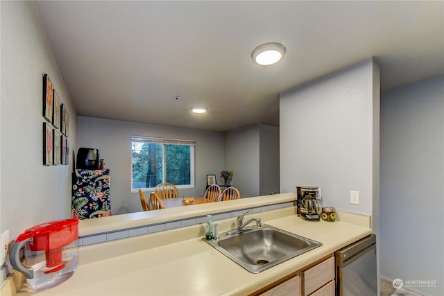 kitchen featuring kitchen peninsula, sink, light brown cabinets, and dishwasher