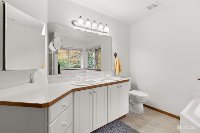 bathroom featuring vanity, toilet, tile patterned flooring, and a bathtub