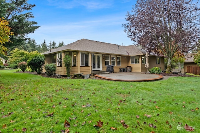 rear view of property featuring a yard and a patio area