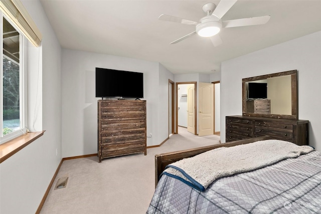 bedroom featuring light colored carpet and ceiling fan