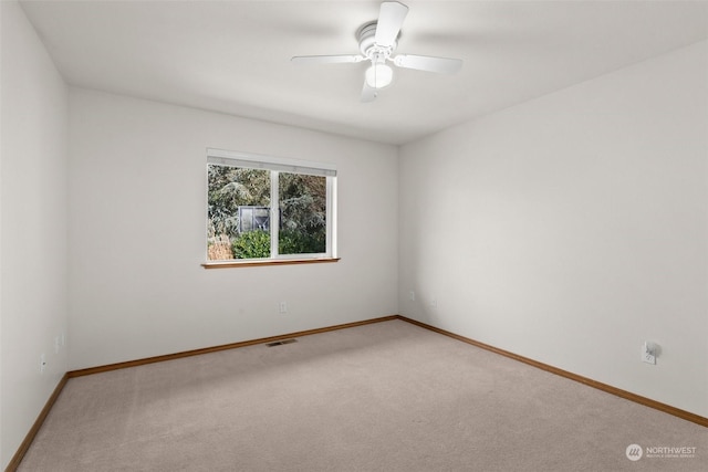 empty room with carpet flooring and ceiling fan