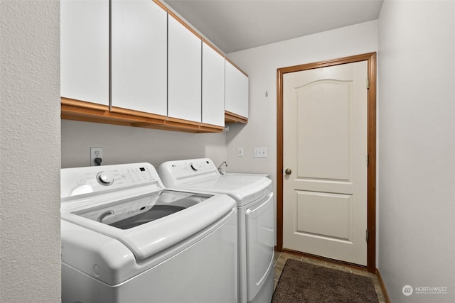 laundry area featuring independent washer and dryer and cabinets