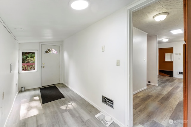 entrance foyer with light hardwood / wood-style flooring and vaulted ceiling