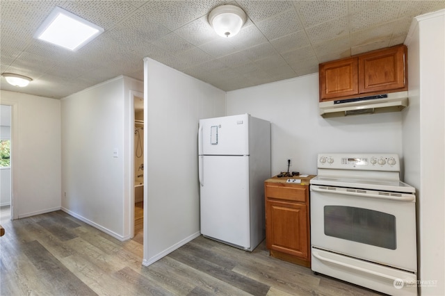 kitchen featuring light hardwood / wood-style flooring and white appliances