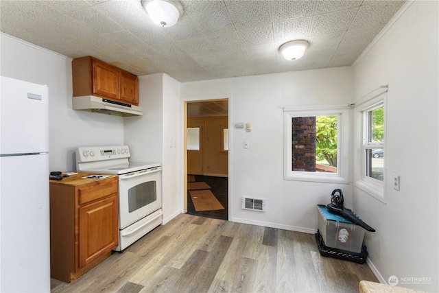 kitchen featuring white appliances, light hardwood / wood-style floors, and ornamental molding