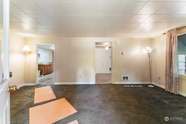 carpeted empty room featuring ceiling fan