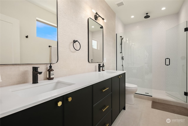 bathroom featuring vanity, a shower with shower door, toilet, and tile patterned floors