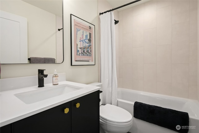 full bathroom featuring vanity, shower / bath combo with shower curtain, and toilet