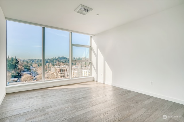 unfurnished room featuring light hardwood / wood-style floors