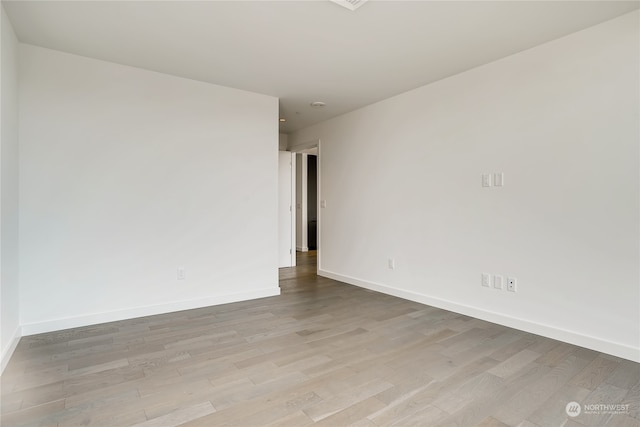 unfurnished room with light wood-type flooring