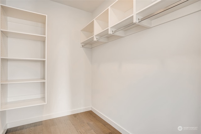 spacious closet with light hardwood / wood-style floors