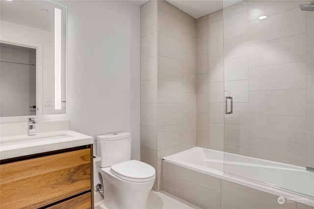 full bathroom featuring vanity, shower / bath combination with glass door, and toilet