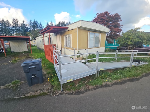 view of side of home featuring a storage shed