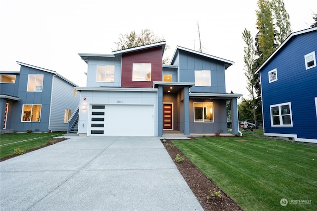 contemporary house featuring a front yard and a garage