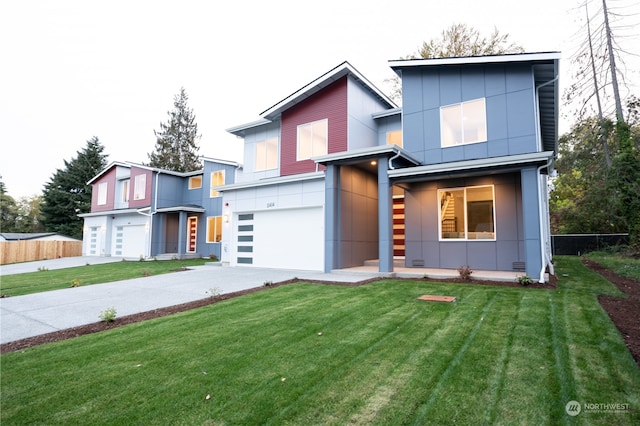 modern home featuring a front lawn and a garage