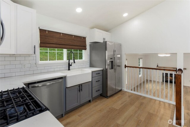 27705 23rd Ave S, Federal Way, WA 98003 - kitchen with light countertops, light wood finished floors, appliances with stainless steel finishes, and a sink