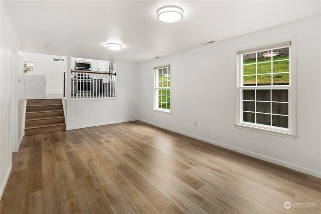 27705 23rd Ave S, Federal Way, WA 98003 - spare room with stairs, baseboards, visible vents, and wood finished floors