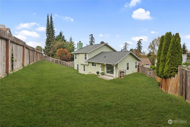 27705 23rd Ave S, Federal Way, WA 98003 - back of property featuring a patio, a chimney, a shingled roof, a fenced backyard, and a yard