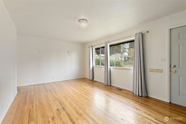 unfurnished room with light wood-type flooring