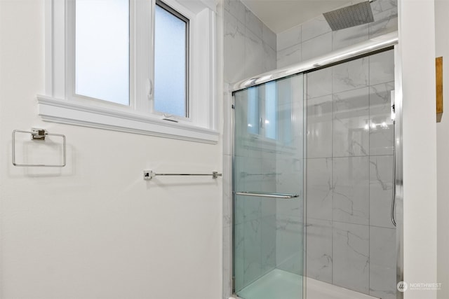 bathroom with a shower with shower door