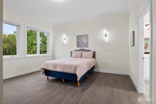 bedroom with crown molding and dark hardwood / wood-style floors