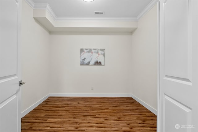 spare room featuring ornamental molding and hardwood / wood-style flooring