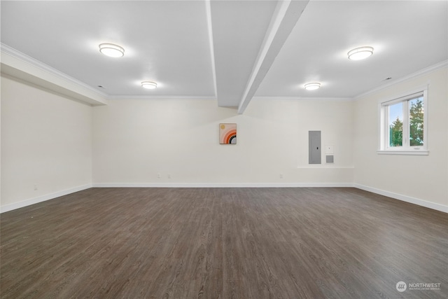 basement featuring ornamental molding, electric panel, and dark wood-type flooring