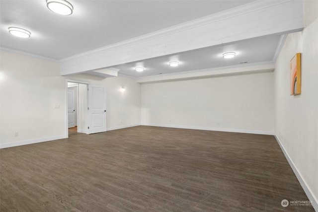 empty room featuring dark wood-type flooring and crown molding