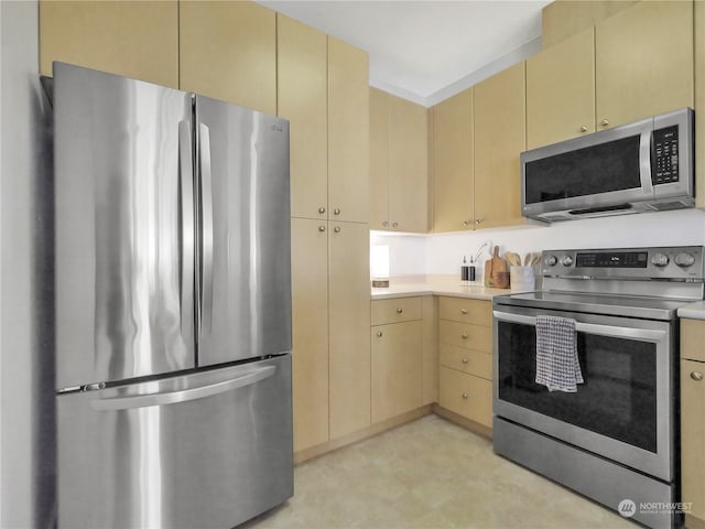 kitchen with appliances with stainless steel finishes and light brown cabinets