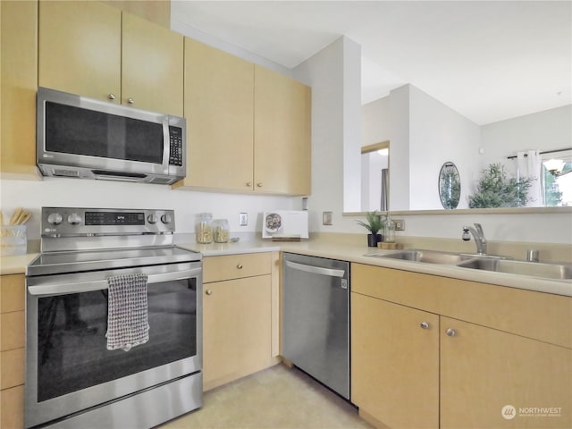 kitchen featuring appliances with stainless steel finishes, sink, and light brown cabinets