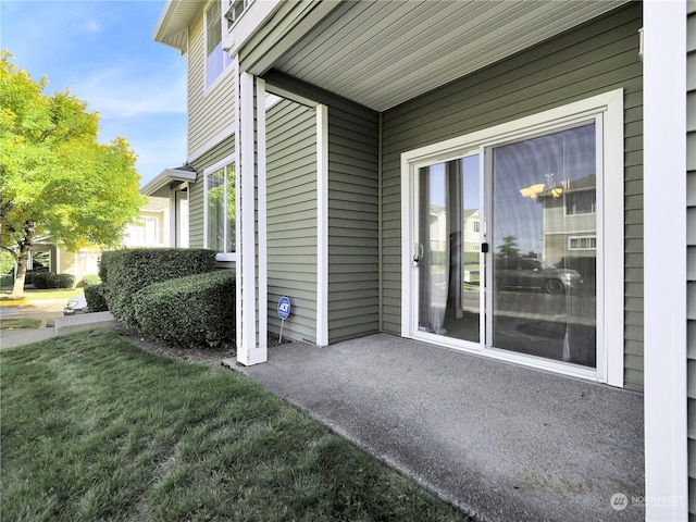 entrance to property featuring a yard