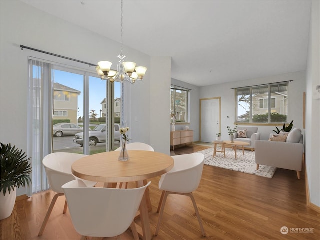 dining room with an inviting chandelier and hardwood / wood-style floors