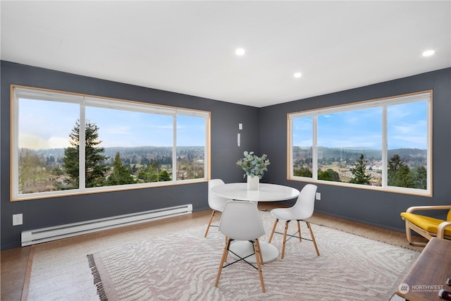 dining space featuring a wealth of natural light, a baseboard radiator, and recessed lighting