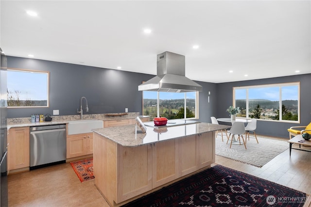 kitchen with stainless steel dishwasher, light brown cabinets, a sink, island range hood, and electric stovetop