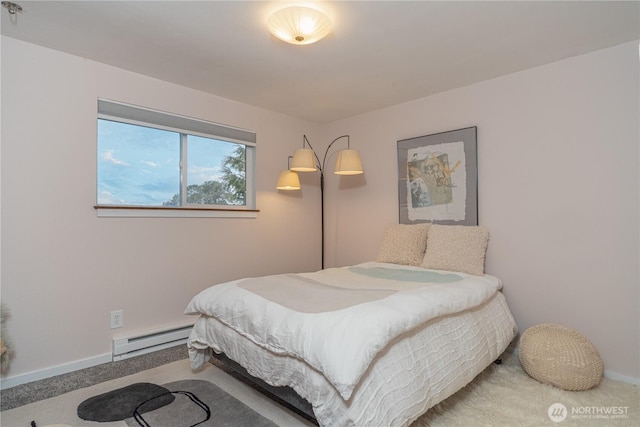 bedroom featuring a baseboard radiator, baseboards, and carpet flooring