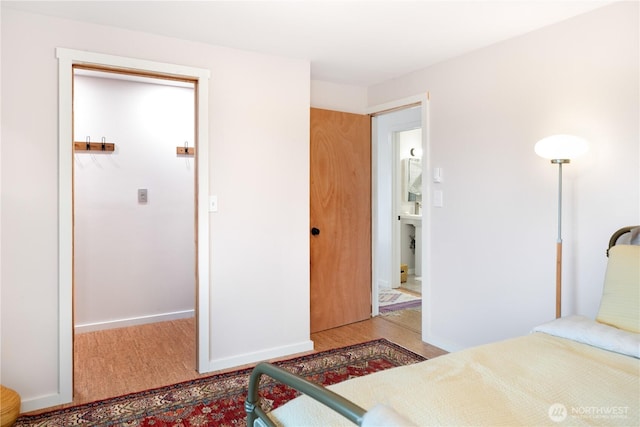 bedroom with wood finished floors and baseboards