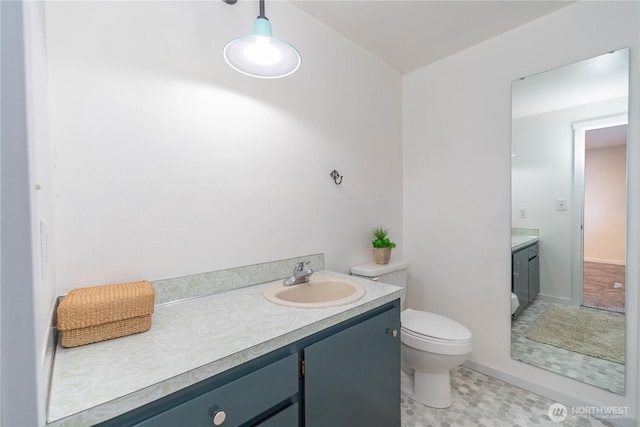 bathroom featuring toilet and vanity