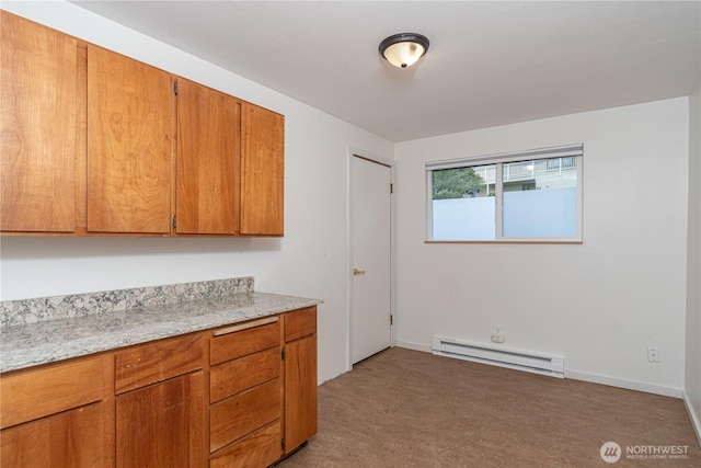 kitchen featuring light carpet, baseboards, light stone counters, brown cabinets, and baseboard heating