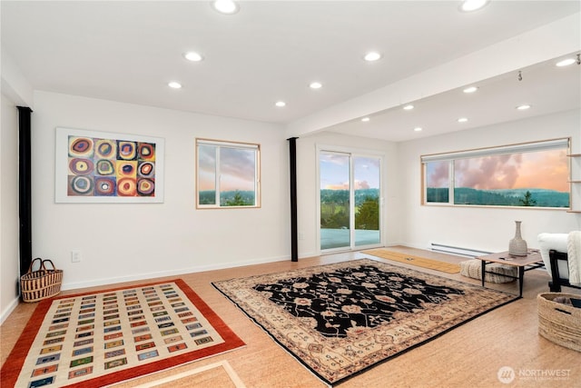 living area featuring recessed lighting, baseboards, and a baseboard radiator