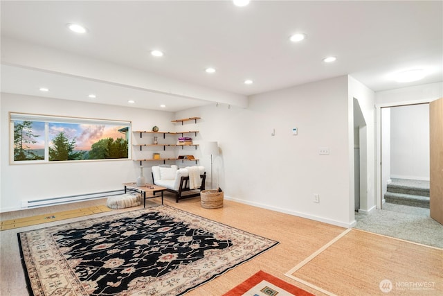 living area featuring baseboards, stairway, baseboard heating, and recessed lighting