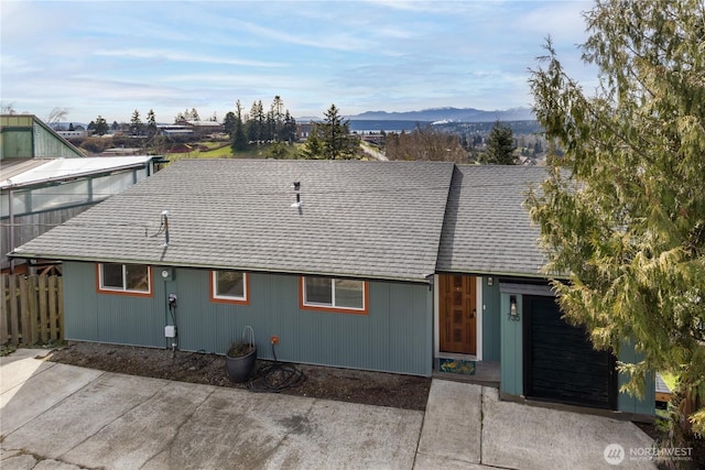 view of front of home featuring a shingled roof and a mountain view