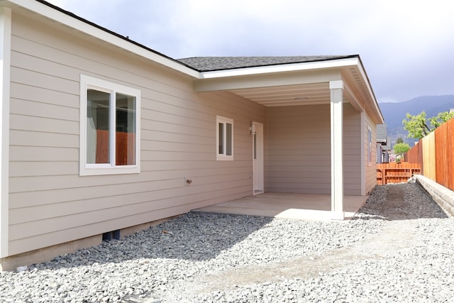 exterior space with a mountain view and a patio area