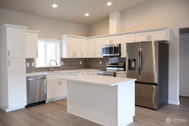 kitchen featuring a center island, appliances with stainless steel finishes, light hardwood / wood-style flooring, and white cabinets