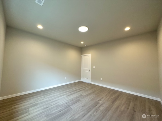 spare room with hardwood / wood-style flooring