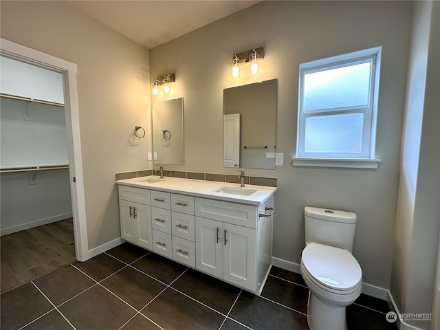 bathroom featuring vanity, toilet, and tile patterned floors