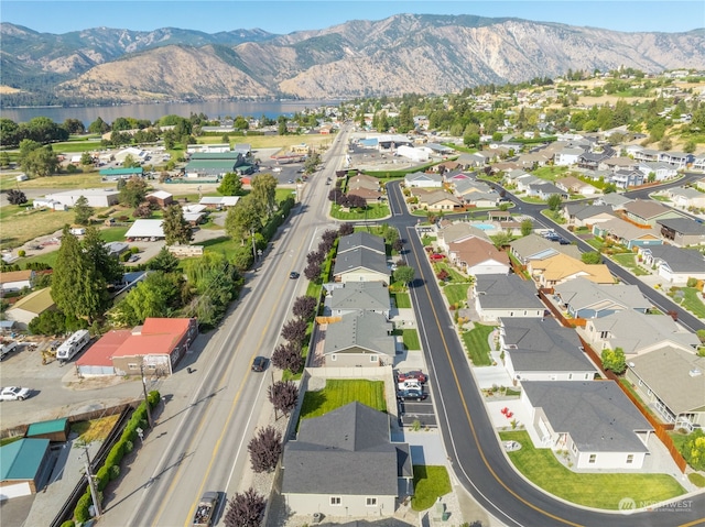 drone / aerial view featuring a water and mountain view