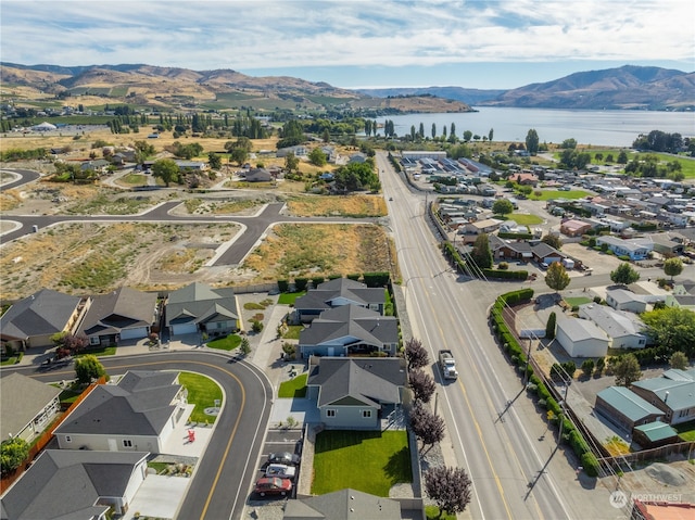 drone / aerial view with a water and mountain view